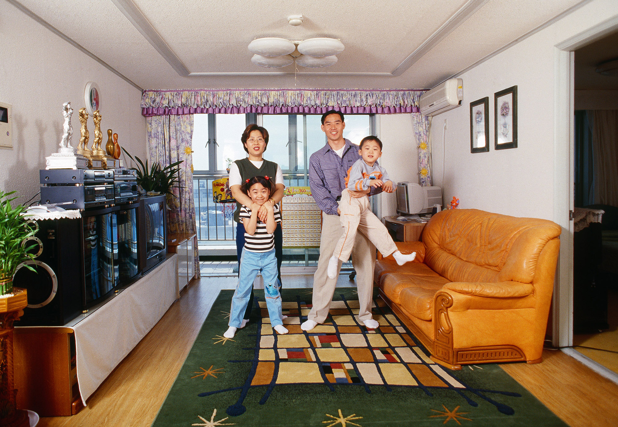 Yeondoo Jung, Evergreen Tower, 2001, C-print, total 32
                  family portraits, 55 × 80 cm (32). Courtesy of the artist.